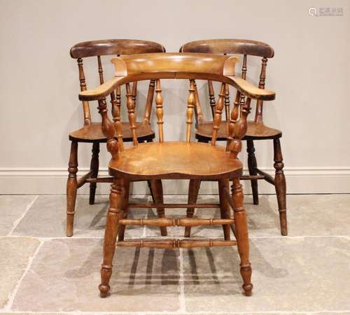 A Victorian elm and beech smokers bow elbow chair, with turn...