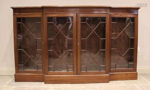 An Edwardian mahogany breakfront bookcase, the moulded top a...