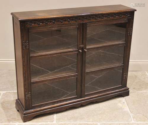 An oak Priory style glazed bookcase, mid 20th century, the r...