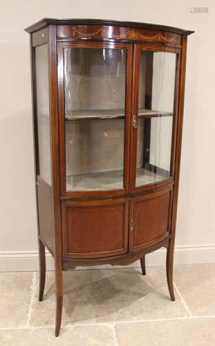 An Edwardian mahogany bowfront display cabinet, the frieze i...