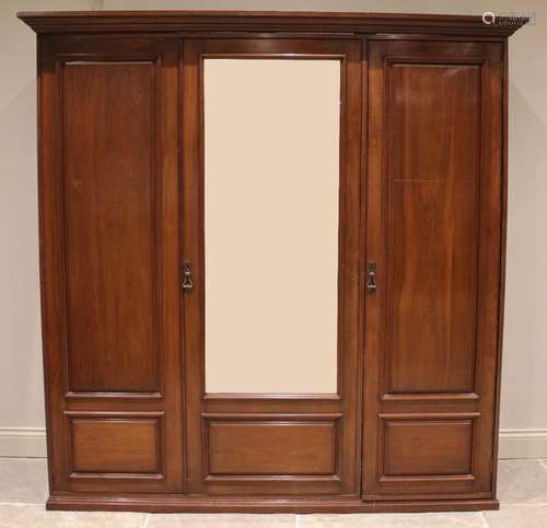 A large Edwardian walnut gentlemans triple wardrobe, the cen...