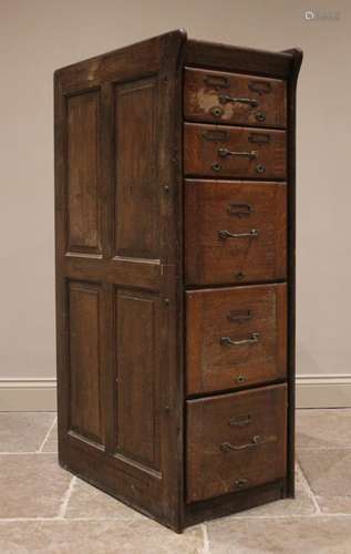 A 1930s oak bank of drawers/filing cabinet, the panelled sid...