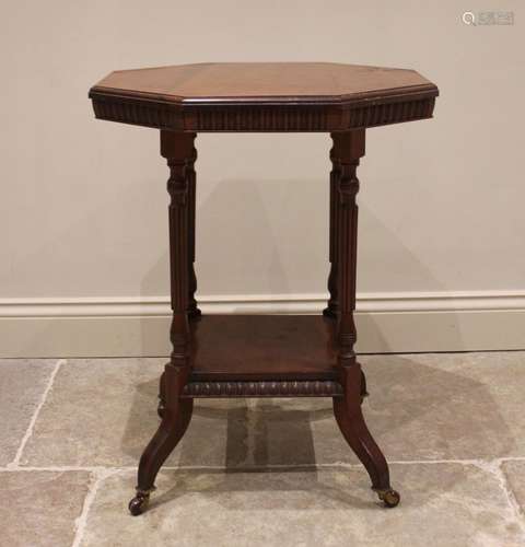 An Edwardian mahogany octagonal top occasional library table...