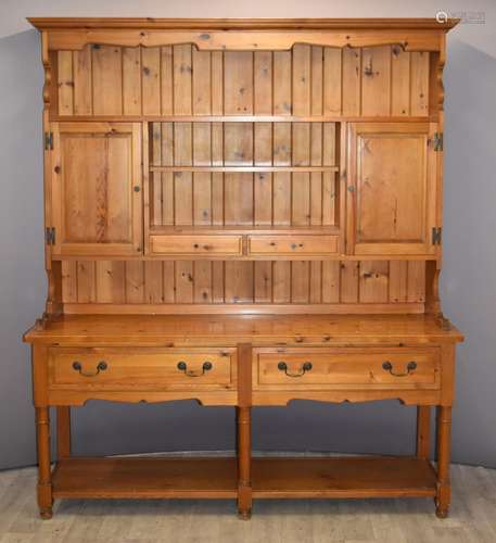 Pine dresser with twin cupboards, two drawers and undershelf...