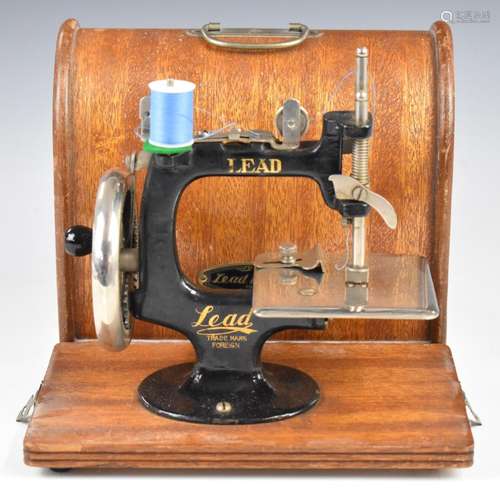 Vintage Lead toy sewing machine, in original wooden case