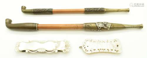 Two Japanese opium pipes together with two Chinese mother-of...