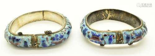 A pair of Chinese silver bangles set with enamel depicting a...