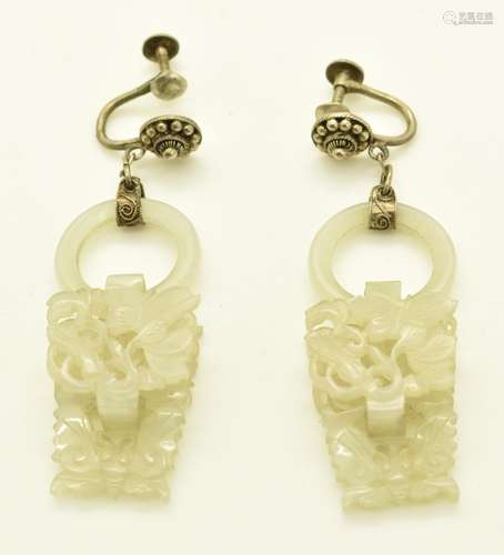 A pair of Chinese silver earrings set with a jade ring and c...