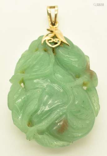 A 14k gold pendant set with carved quartz / jadeite depictin...