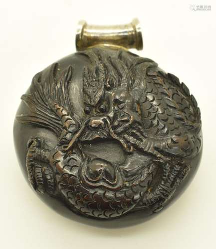 Japanese wooden netsuke carved with a dragon and inlaid sign...