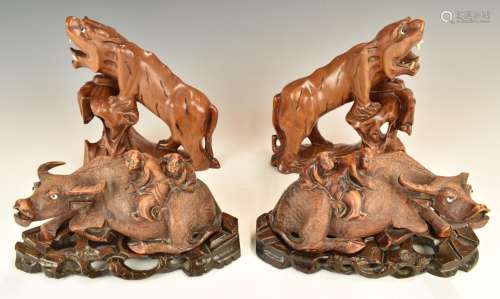 Two pairs of Chinese wooden carvings, one in the form of fig...