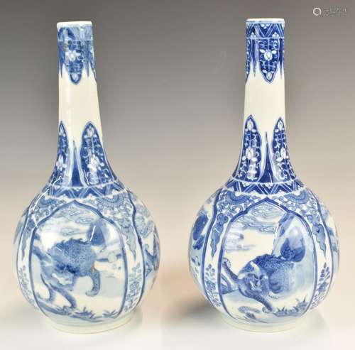 Pair of Chinese 19thCblue and white pedestal vases with drag...