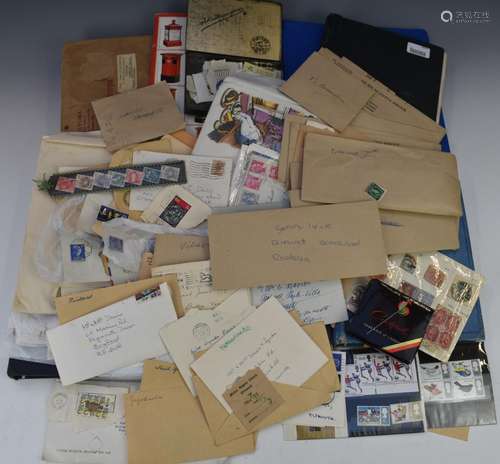 An accumulation of stamps in albums, envelopes and loose, fr...