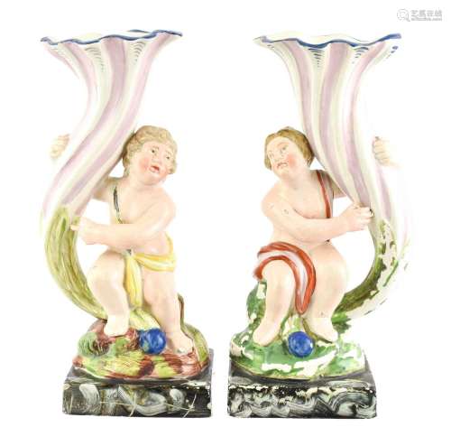 A Pair of Pearlware Figural Spill Vases, circa 1820, as cher...