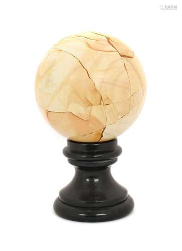 A Marble Orb, on a circular black slate socle21cm diameter