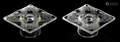 LALIQUE, FRANCE. A PAIR OF CLEAR GLASS SQUARE CANDLE HOLDERS...