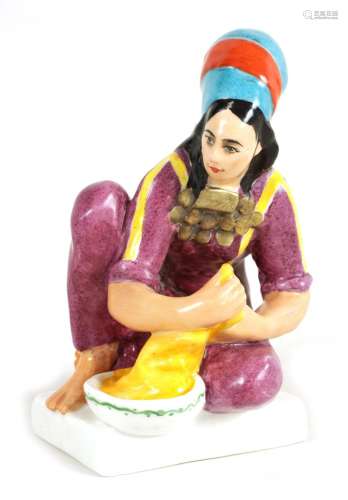A COLOURFUL RUSSIAN SEATED YOUNG LADY FIGURE OF A WASHER GIR...