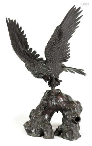 A JAPANESE MEIJI PERIOD PATINATED BRONZE SCULPTURE OF AN EAG...