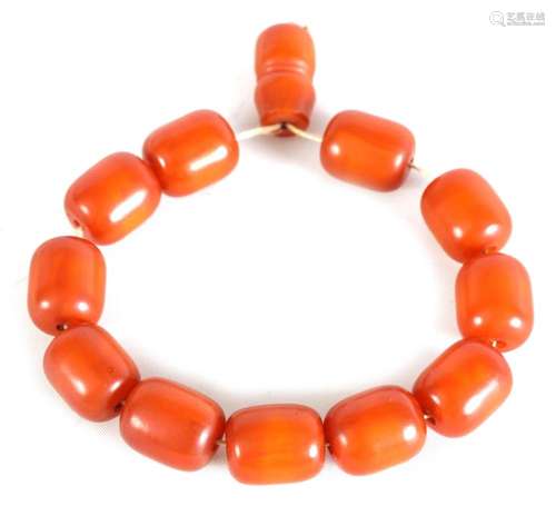 A SET OF OVAL AMBER BEADS