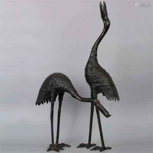 A pair of cast iron cranes, 20th century