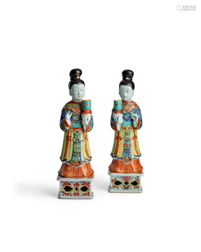 A PAIR OF FAMILLE ROSE 'STANDING LADY' CANDLE HOLDERS Yongzh...