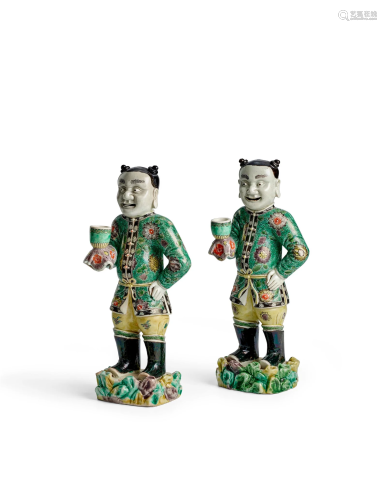 A RARE PAIR OF FAMILLE VERTE 'BOY FOREIGNERS' AS CANDLESTICK...