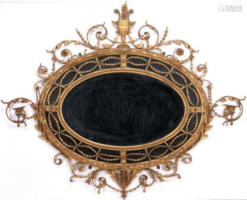 GEORGE III NEOCLASSICAL OVAL GILTWOOD MIRROR WITH CANDLE BRA...