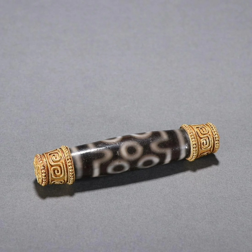 CHINESE GILT-SILVER-MOUNTED DZI BEAD