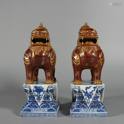 TWO GILDED ON IRON-RED-GLAZED QILIN-FORM PAPERWEIGHTS ON BLU...