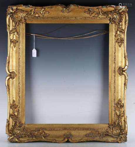 A 19th century swept gilt composition frame of wide section ...