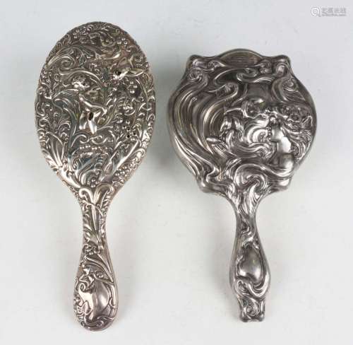 An Art Nouveau plated hand mirror, relief decorated with a m...