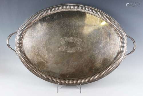 A late Victorian silver oval two-handled tea tray, the centr...