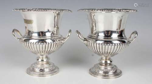 A pair of late Victorian silver campana urns, each with scal...