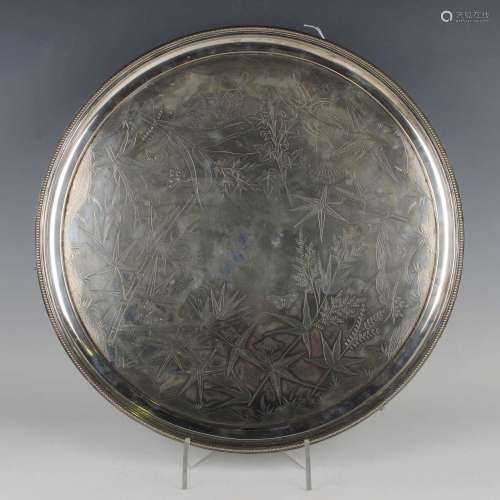 A late Victorian Aesthetic Movement circular plated salver, ...