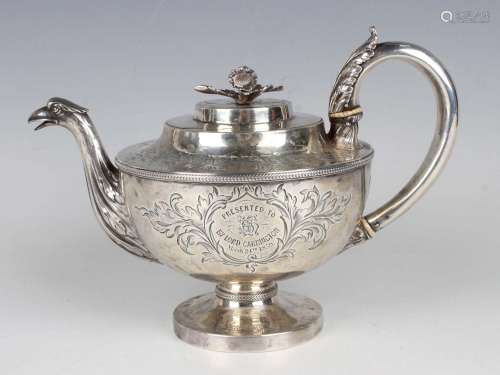 A George III silver circular teapot with flower finial above...