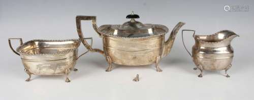 A George V harlequin silver three-piece tea set of girdled c...