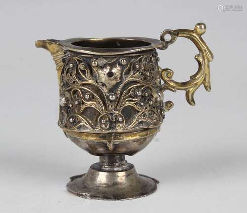 A Continental silver and parcel gilt diminutive jug, possibl...