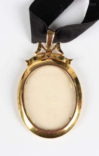 An Edwardian gold mounted oval pendant locket, the glazed fr...