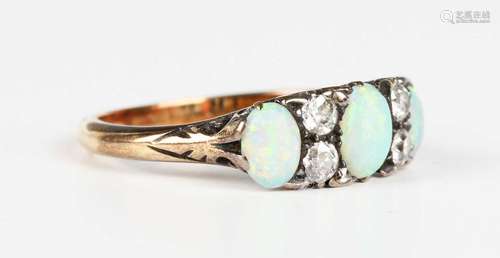 A gold, opal and diamond ring, mounted with three graduated ...