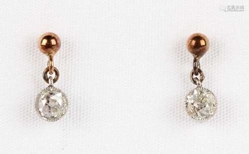 A pair of diamond single stone pendant earrings, each collet...