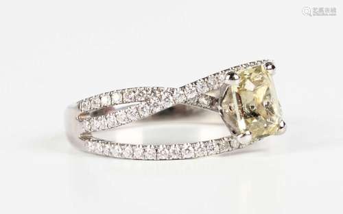 An 18ct white gold, yellow sapphire and diamond ring, claw s...