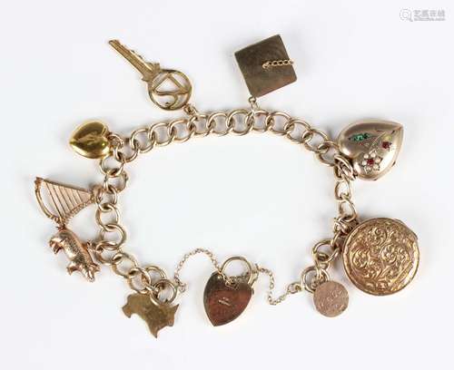 A 9ct gold curblink charm bracelet with a 9ct gold heart sha...