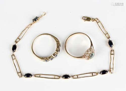 A 9ct gold and sapphire bracelet, claw set with a row of ova...