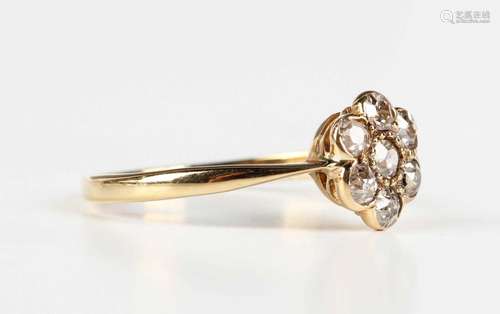 A gold and diamond seven stone cluster ring in a flowerhead ...