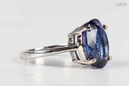 An 18ct white gold ring, claw set with an oval cut tanzanite...