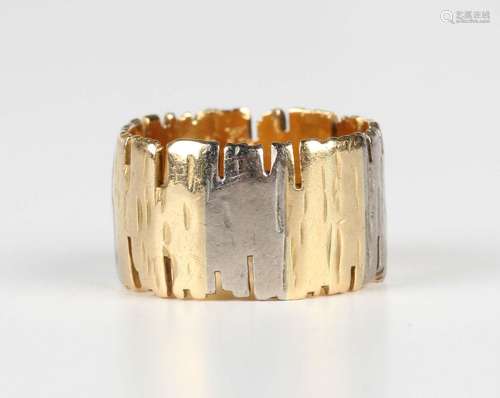 An 18ct two colour gold wind band ring in an abstract textur...