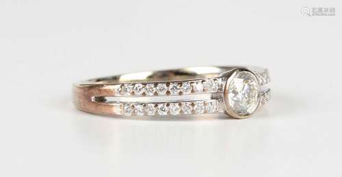 A white gold and diamond ring, collet set with the principal...