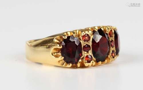 A gold and garnet ring, mounted with the three principal ova...