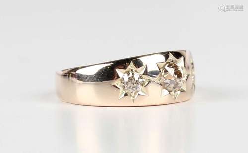 A gold and diamond three stone ring, star gypsy set with cus...