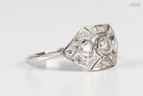 A platinum and diamond panel shaped ring, mounted with a gra...